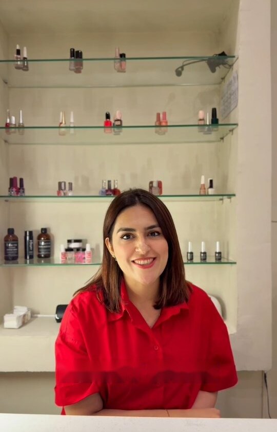 Safa Tariq, founder of MB Nail Bar, at the studio's polish shelf